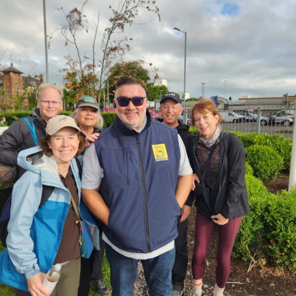 Driver, David Warren, with 5 tourists in a Belfast garden.