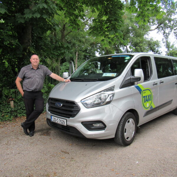 Tour driver along-side taxi van.