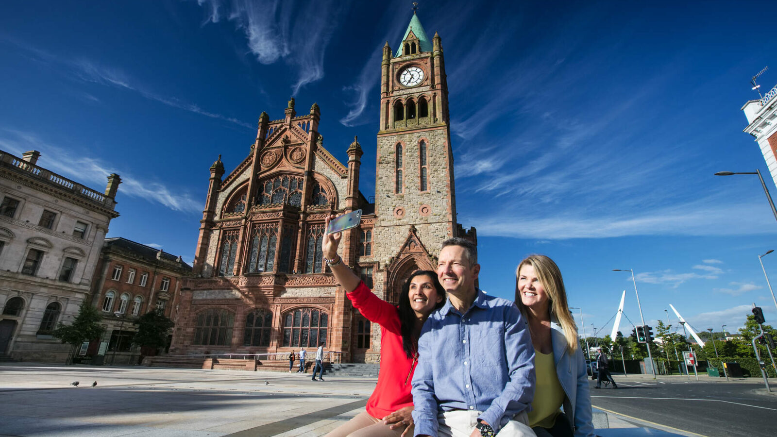 Visitors enjoying the sunshine outside the Guild hall Derry